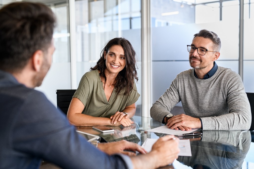 Couple meeting with a financial advisor in a modern office