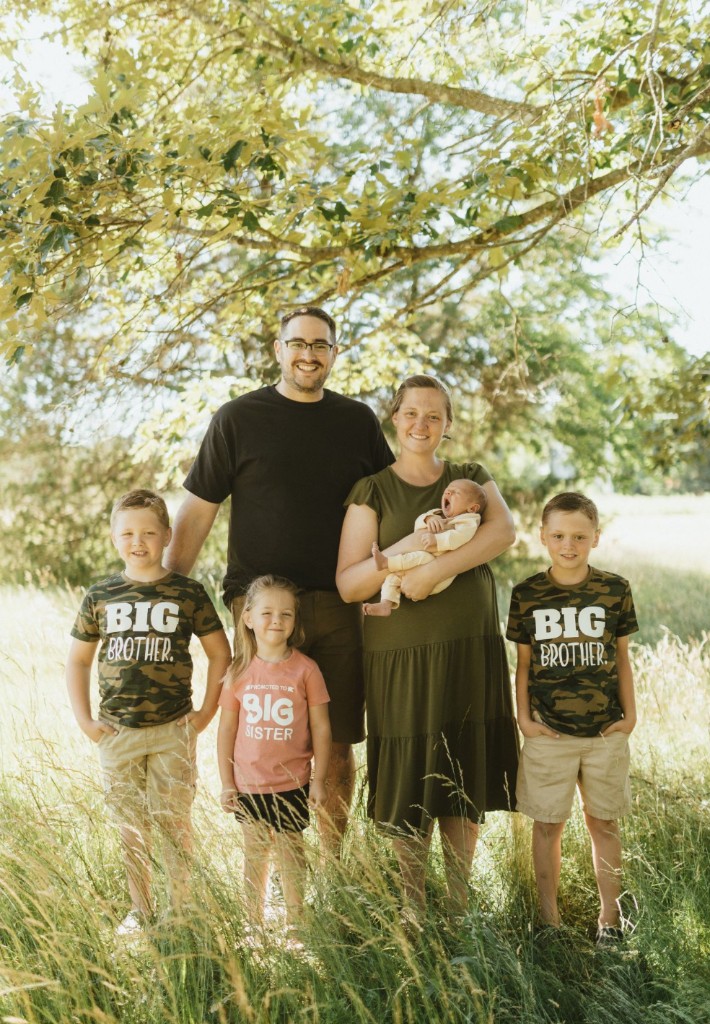 Doug Root with his wife Kelly and their four children outdoors